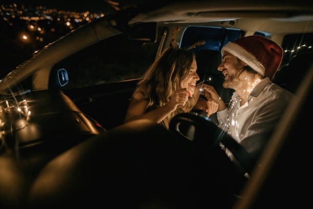 Photo of young couple celebrating New Year in the car.